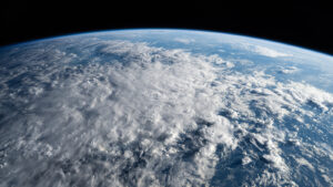 Earth's Atmosphere from Space with various cloud formations visible.